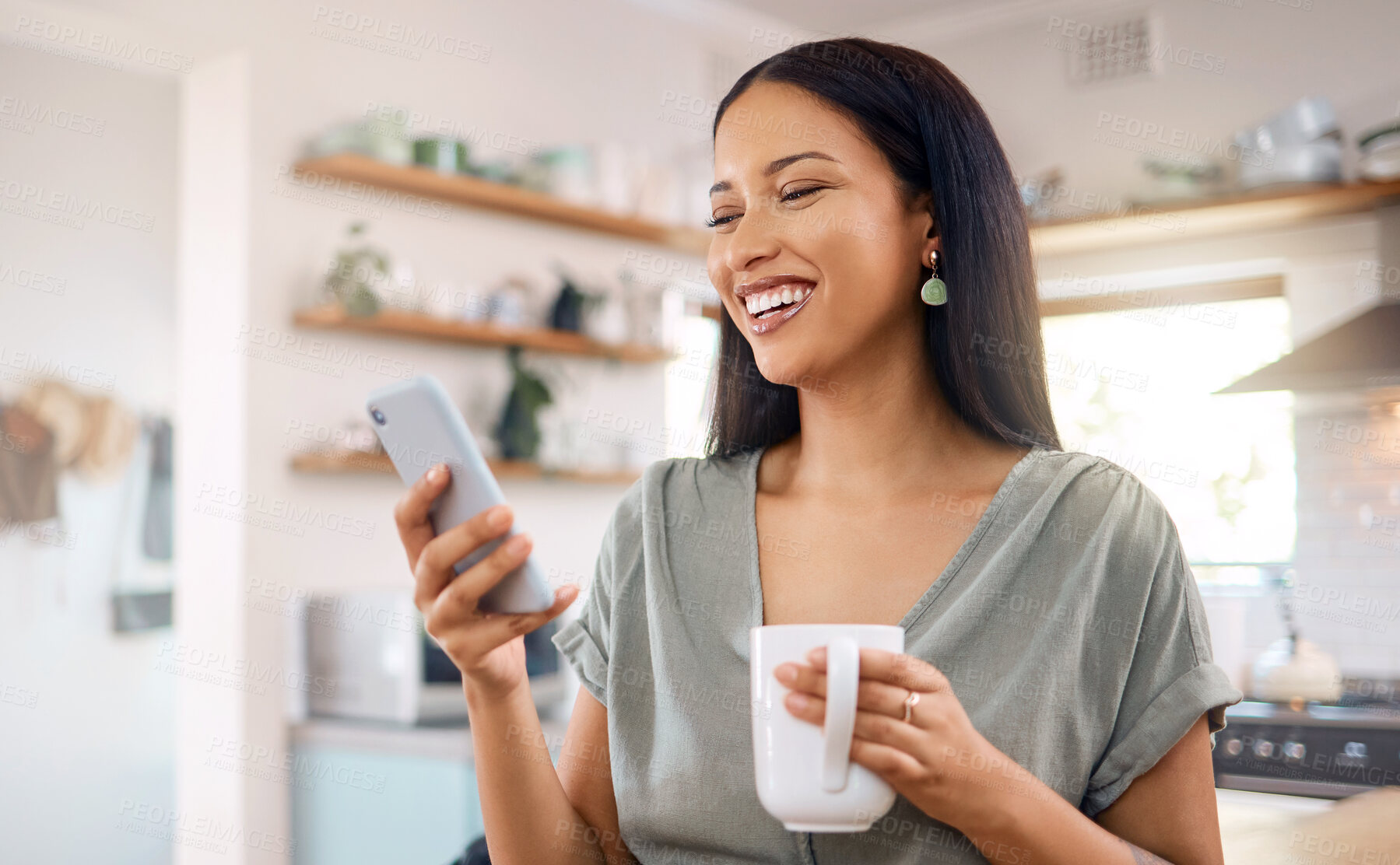 Buy stock photo Phone, coffee and funny woman in kitchen for social media, text app or reading message with gif. Laugh, drink and person at home with mobile for online post, communication and meme on internet