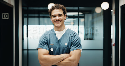 Buy stock photo Portrait, man and nurse in hospital with arms crossed, smile and knowledge from medical internship. Happy, person and healthcare intern in clinic with confidence, about us and pride for patient care.