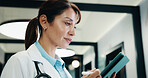 Reading, doctor and woman with tablet in hospital, medical journal and healthcare protocol revision. Review, research and mature gp with ebook on clinical diagnosis, tech and policy update newsletter
