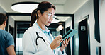 Review, doctor and woman with tablet in hospital, medical journal and healthcare protocol revision. Reading, research and mature gp with ebook on clinical diagnosis, tech and policy update newsletter