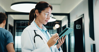 Buy stock photo Review, doctor and woman with tablet in hospital, medical journal and healthcare protocol revision. Reading, research and mature gp with ebook on clinical diagnosis, tech and policy update newsletter