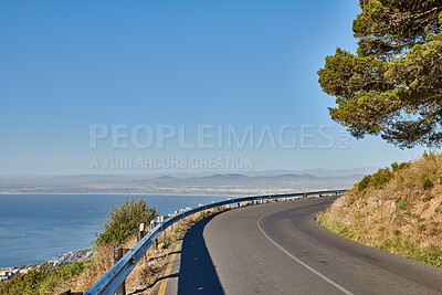 Buy stock photo Landscape, blue sky and road by ocean for travel, tourist destination and journey outdoor. Empty, background and street with scenic route, highway and seaside for vacation, trip and holiday by coast