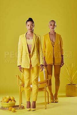 Buy stock photo Serious, portrait and women with eyeshadow, fashion and confident with makeup for beauty and fantasy. Creative, fruit and people with pride for stylish clothes, yellow aesthetic and studio background