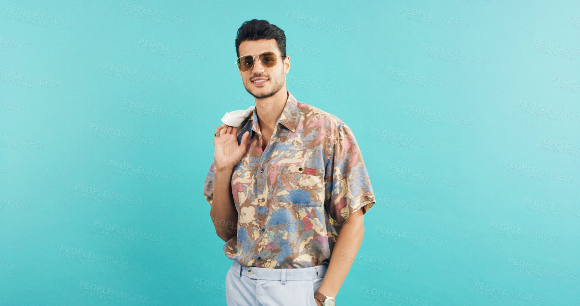 Buy stock photo Fashion, portrait and sunglasses with man in studio for holiday clothing or retro aesthetic. Shades, space and style with person on blue background for summer travel or vacation apparel and clothes