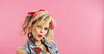 Portrait, retro and flirty woman in studio with fashion, accessories and 80s style. Blow kiss, stylish and edgy person with confident, cosmetics and funky jewelry on pink background and space