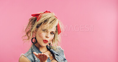 Buy stock photo Portrait, retro and flirty woman in studio with fashion, accessories and 80s style. Blow kiss, stylish and edgy person with confident, cosmetics and funky jewelry on pink background and space