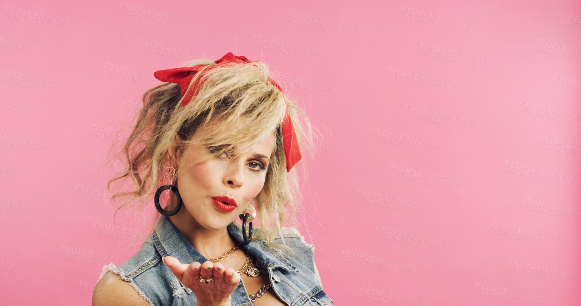 Buy stock photo Portrait, retro and flirty woman in studio with fashion, accessories and 80s style. Blow kiss, stylish and edgy person with confident, cosmetics and funky jewelry on pink background and space
