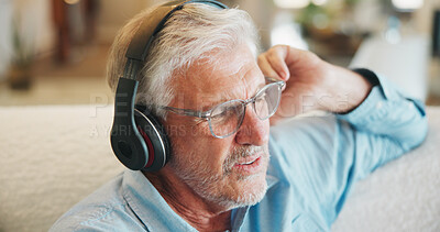Buy stock photo Music, relax and senior man with headphones on sofa with digital audio, playlist or streaming in home. Radio, earphones and old person in living room with retirement, weekend or sound in house
