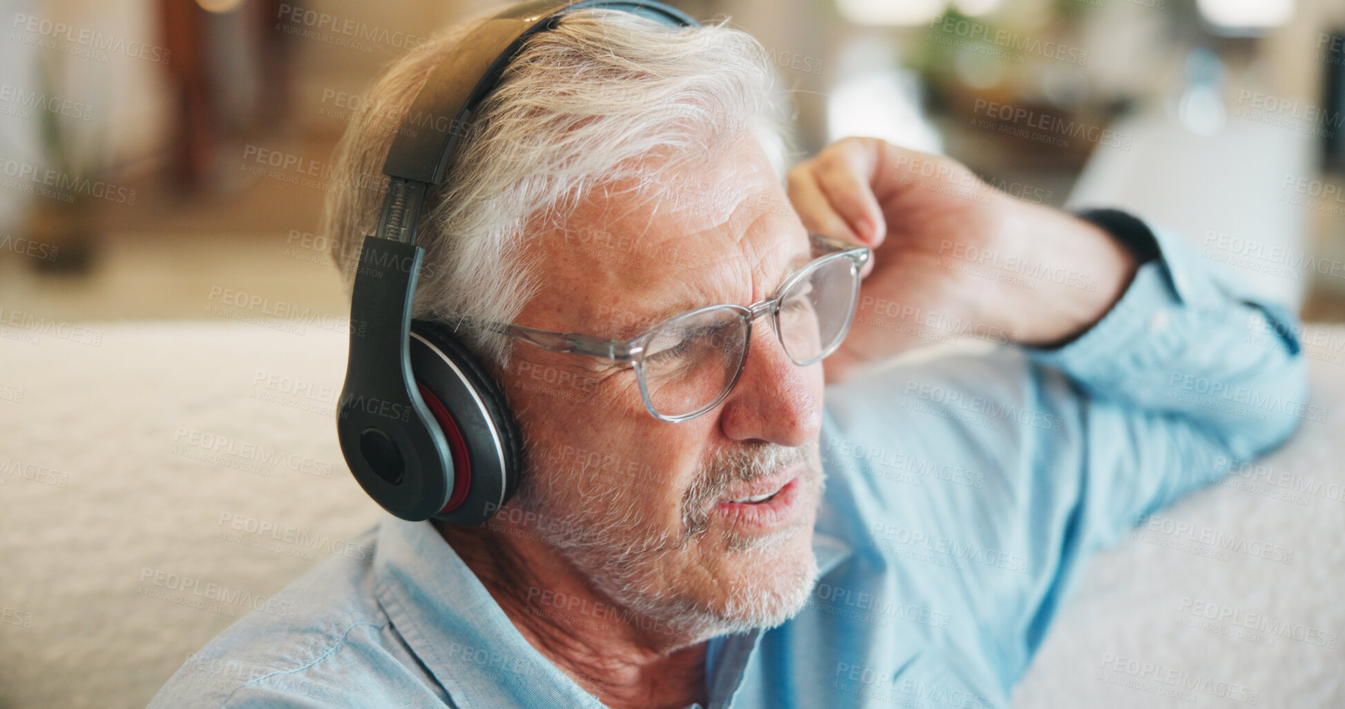 Buy stock photo Music, relax and senior man with headphones on sofa with digital audio, playlist or streaming in home. Radio, earphones and old person in living room with retirement, weekend or sound in house