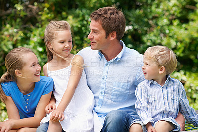 Buy stock photo Dad, children and happy in park with love, parent care and bonding on fathers day. Man, talking and outdoor with kids for family relationship, support and wellness with appreciation for connection