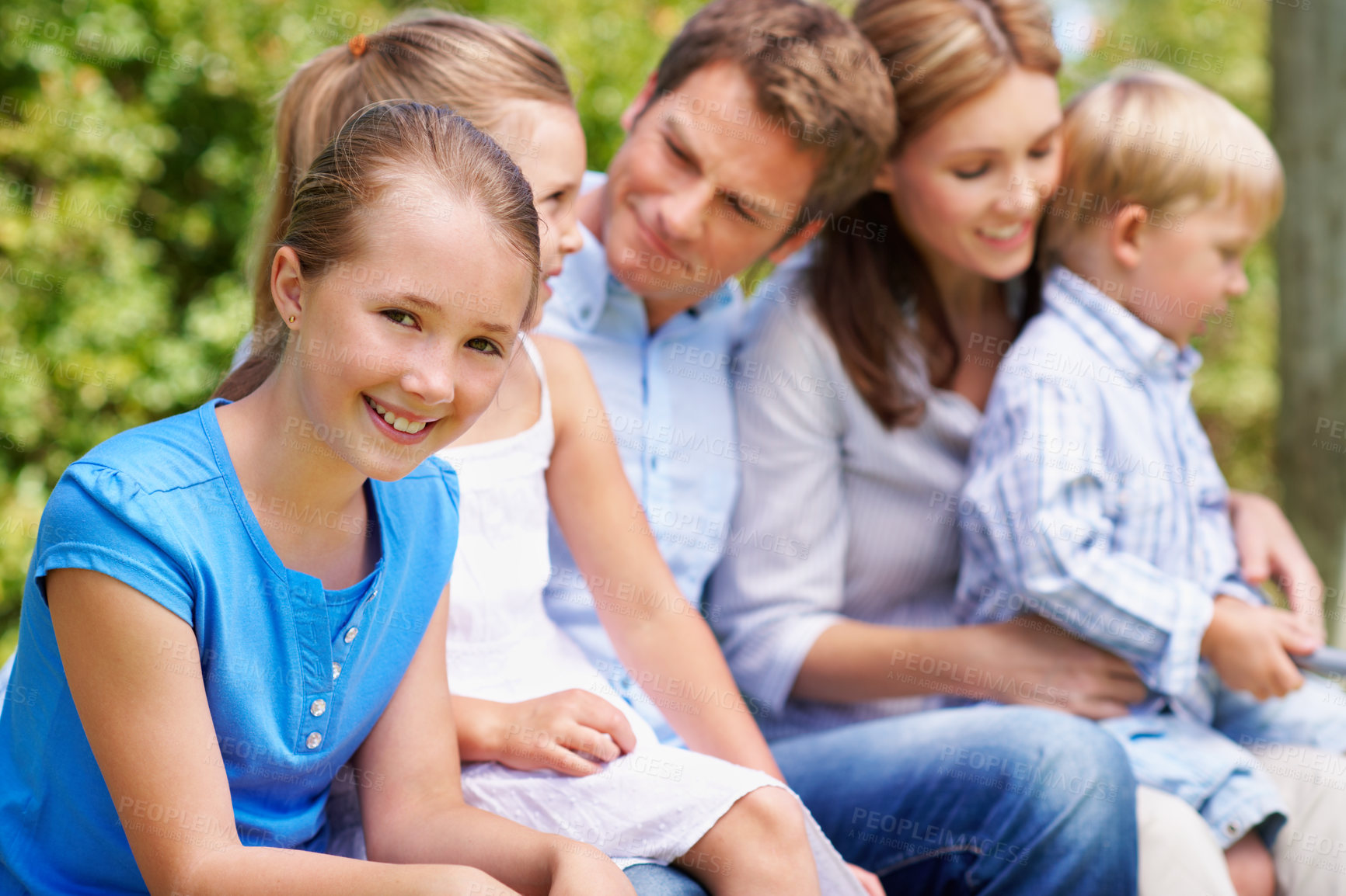 Buy stock photo Portrait, travel and kid in nature with family, adventure and parental support on summer holiday. Smile, daughter and people at park with siblings, affection and bonding together on vacation getaway