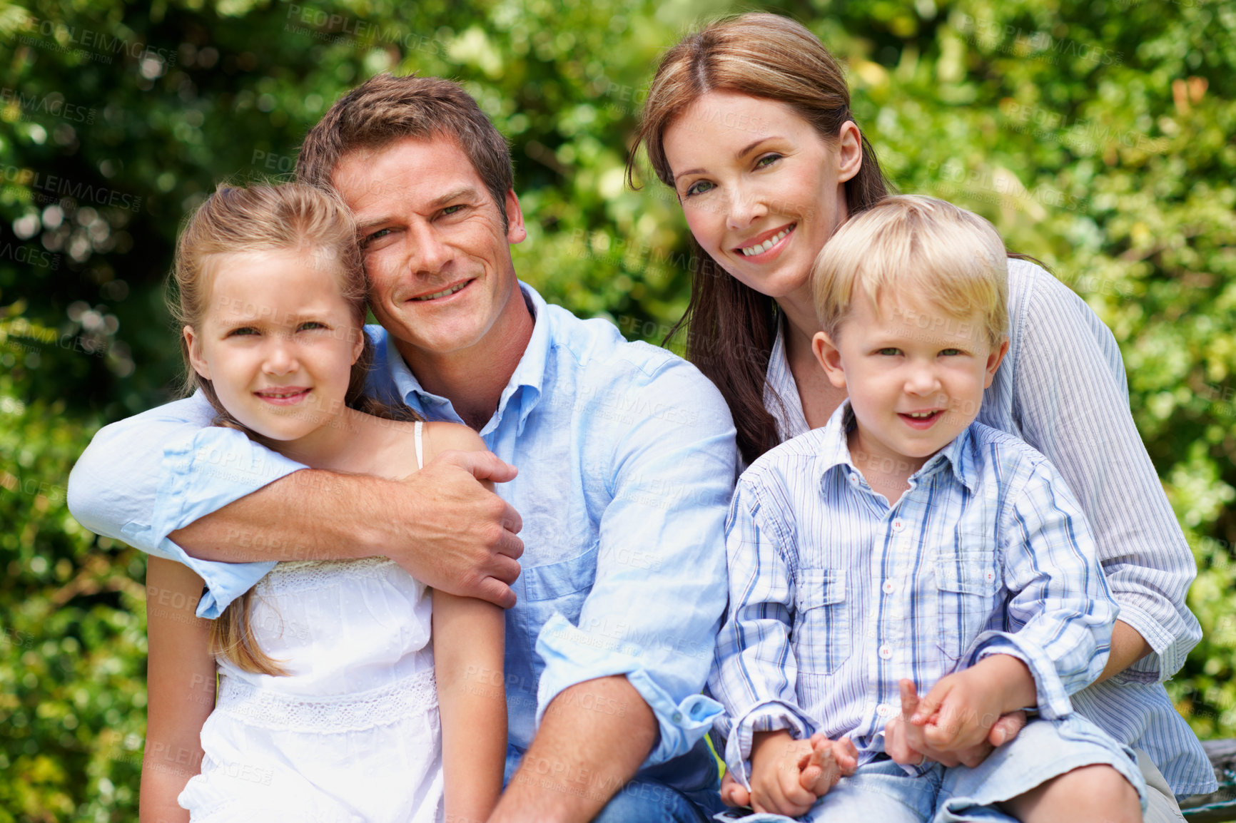 Buy stock photo Parents, children and outdoor in portrait for love, bonding and family wellness in nature. Dad, mom and siblings with hug for happiness, relationship support and relax in garden on summer holiday