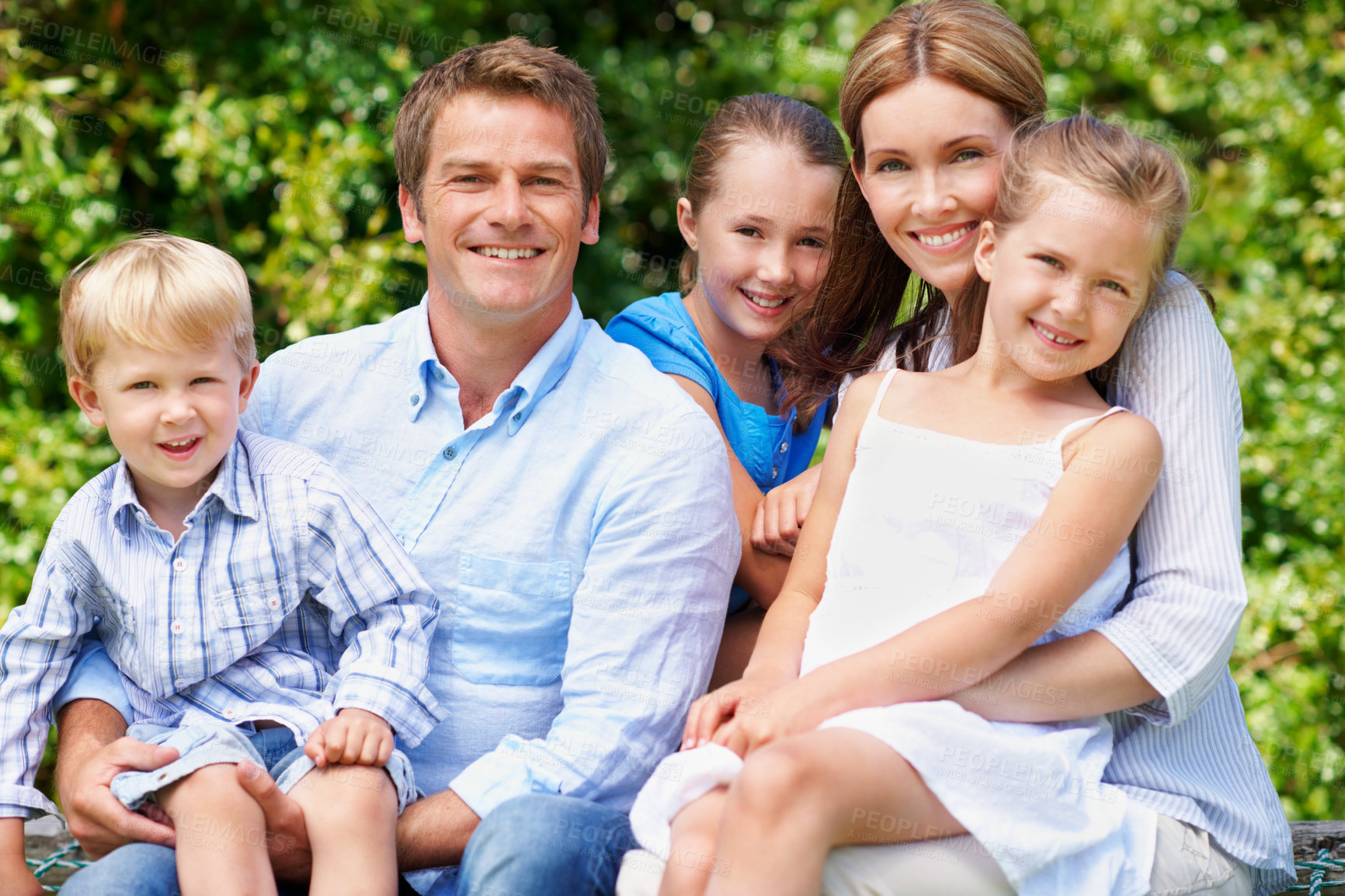 Buy stock photo Portrait, relax and summer with family outdoor together for bonding, love or support. Backyard, security or smile with mom, dad and sibling children in garden of home for break, connection or growth