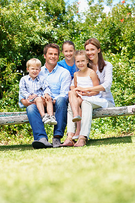 Buy stock photo Happy, parents and relax with kids at park for love, affection and bonding on holiday trip. Portrait, people and bench with children for support, family connection and vacation getaway in countryside