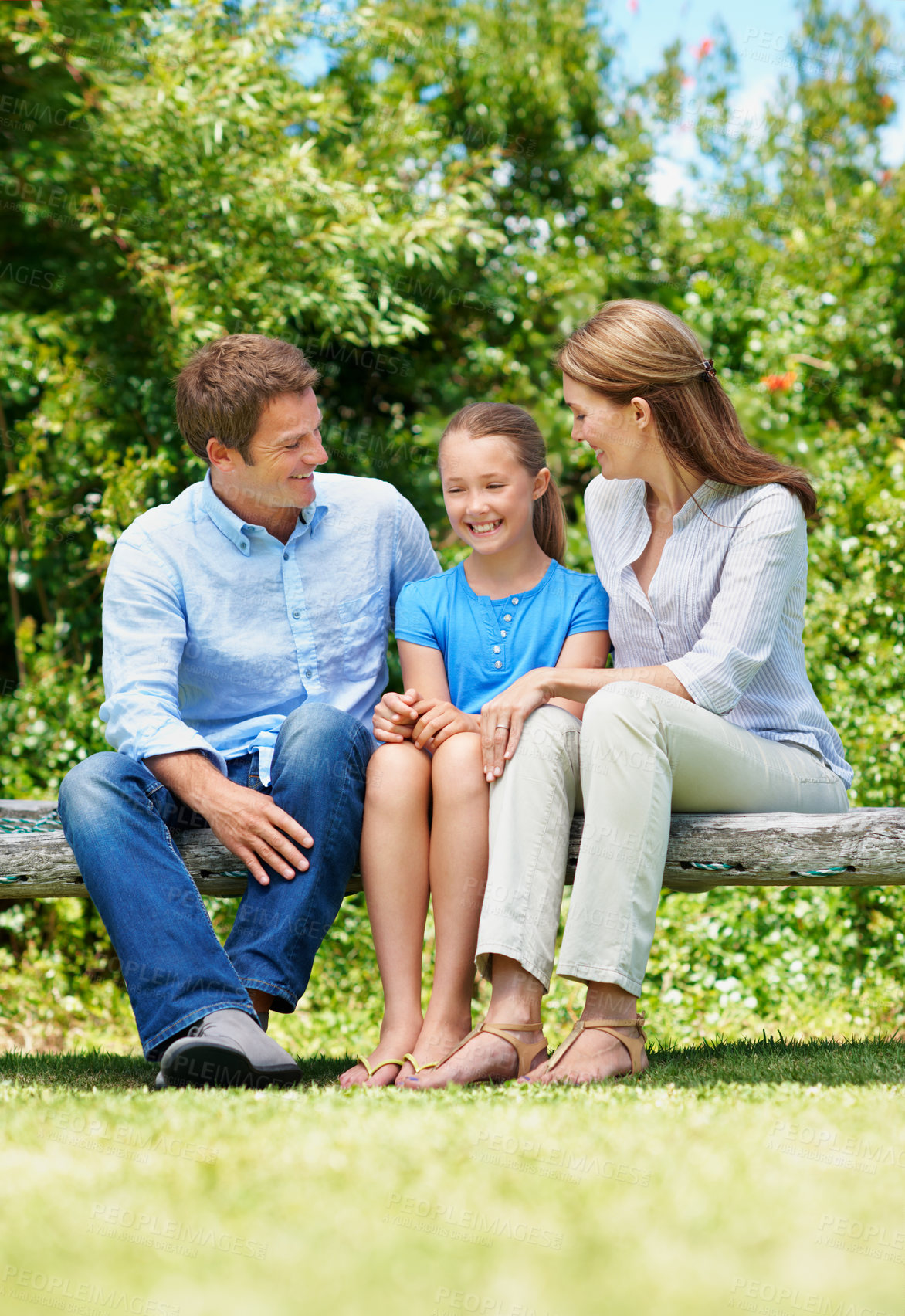 Buy stock photo Break, love and relax with family on swing in backyard together for bonding or conversation. Daughter, parents and summer in garden of home with happy people outdoor for relationship security