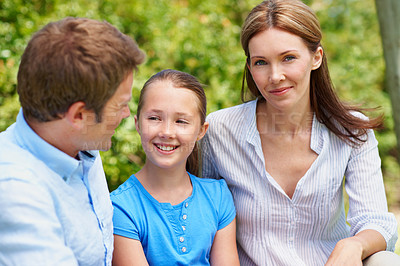 Buy stock photo Parents, child and outdoor with smile for love, bonding and family wellness in nature. Dad, daughter and portrait of mom with happiness, relationship support and relax in garden on summer holiday
