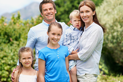 Buy stock photo Portrait, parents and smile with kids in nature for love, affection and bonding together on holiday. Happy, people and children for support, family connection and vacation getaway in countryside