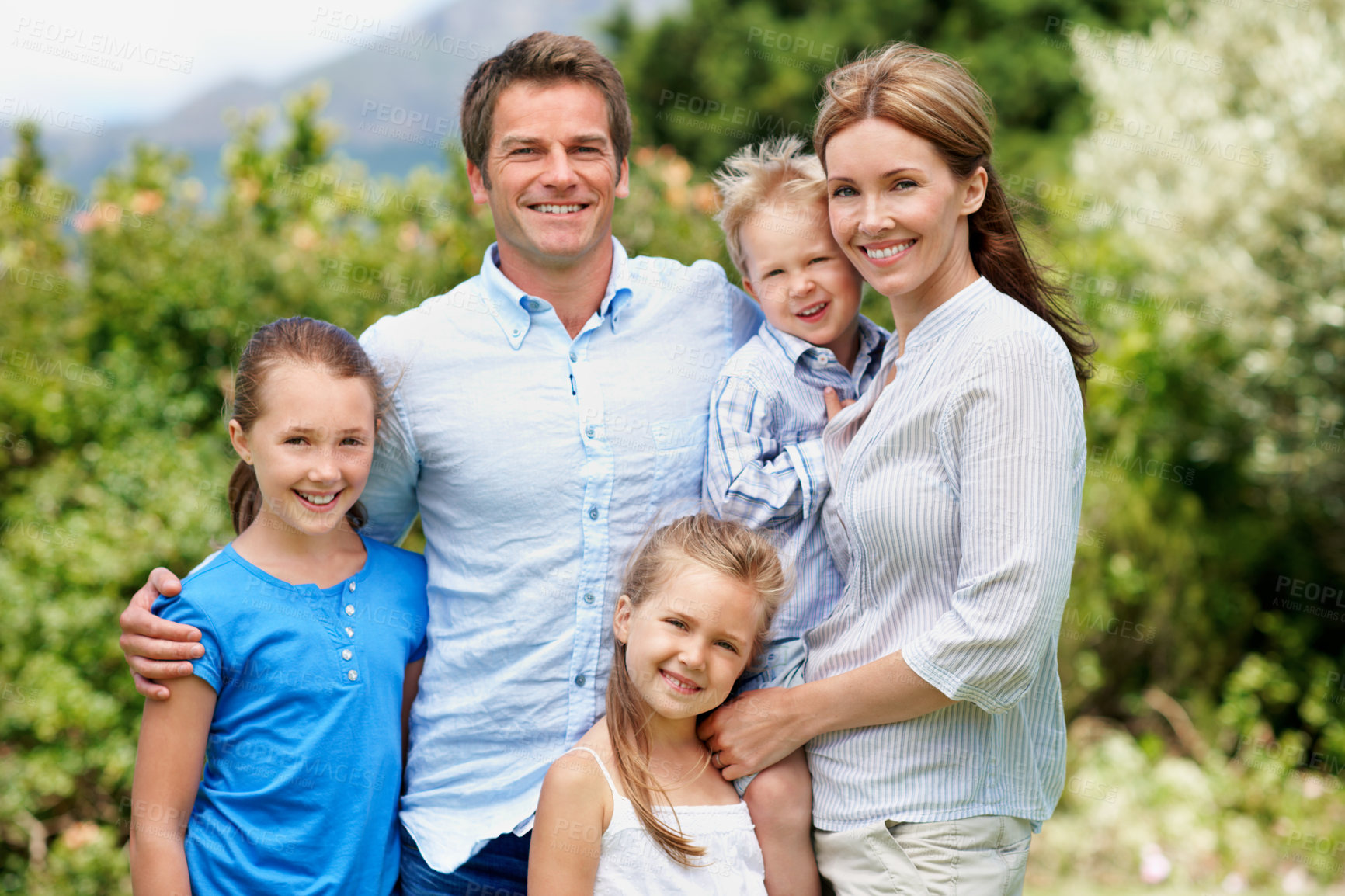 Buy stock photo Portrait, parents and happy with children in nature for love, summer holiday and bonding together. Smile, people and affection with kids, family connection and weekend break on vacation trip outdoor