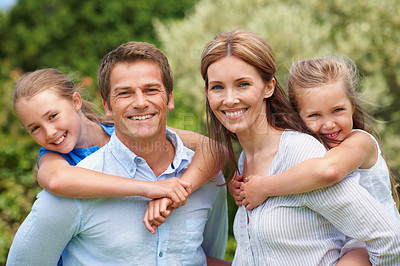 Buy stock photo Portrait, parents and piggyback children in nature for love, parental support and bonding on holiday. Smile, people and embrace kids with affection, family connection and playful fun on vacation trip