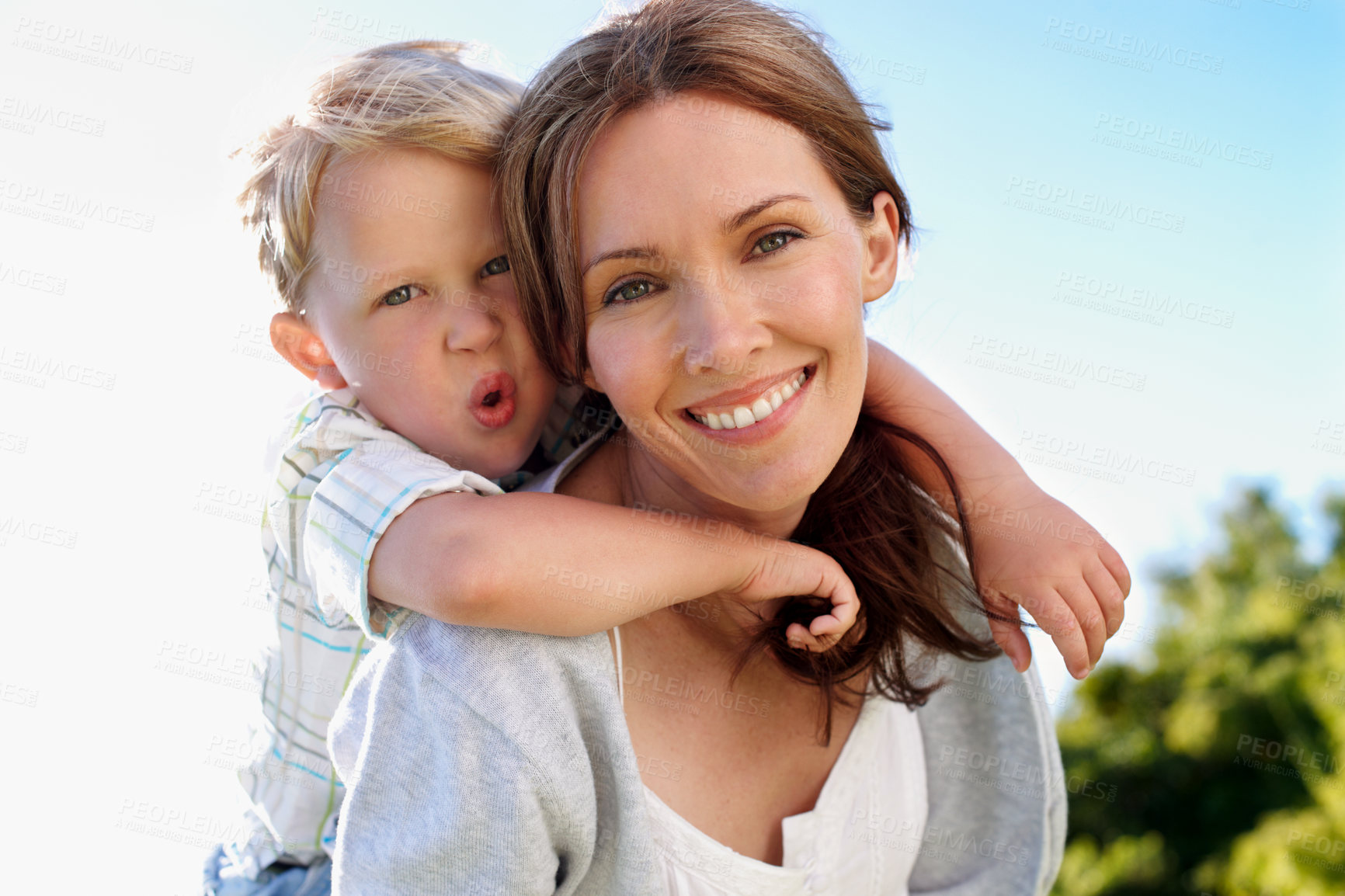 Buy stock photo Portrait, mother and piggyback child in nature for love, parent support and bonding on holiday. Smile, woman or embrace with kid for affection, family connection and playful activity on vacation trip