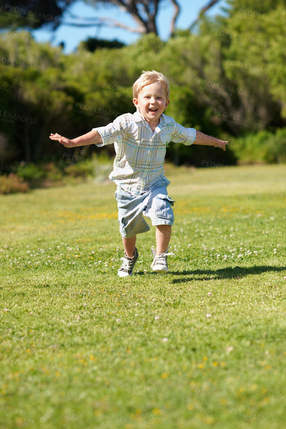 Buy stock photo Happy, child and running in portrait at park for flying game, imaginative play and healthy growth. Cheerful, boy kid and energy on weekend for fun development, fantasy airplane and freedom on grass