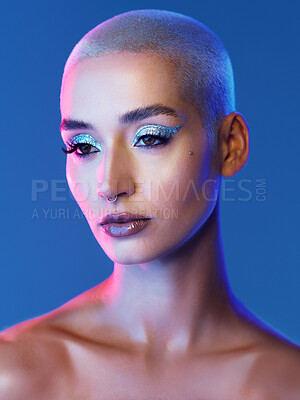 Buy stock photo Woman, makeup and eyeshadow in studio with glitter, blonde hair and reflection for edgy aesthetic. Creative, person and beauty cosmetics with shimmer, glowing skin and piercing on blue background.