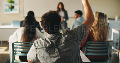 Buy stock photo Learning, man and raised hand for question in college, knowledge and development with teacher. Person, education or student ask in lesson, answer and participation from back at university classroom