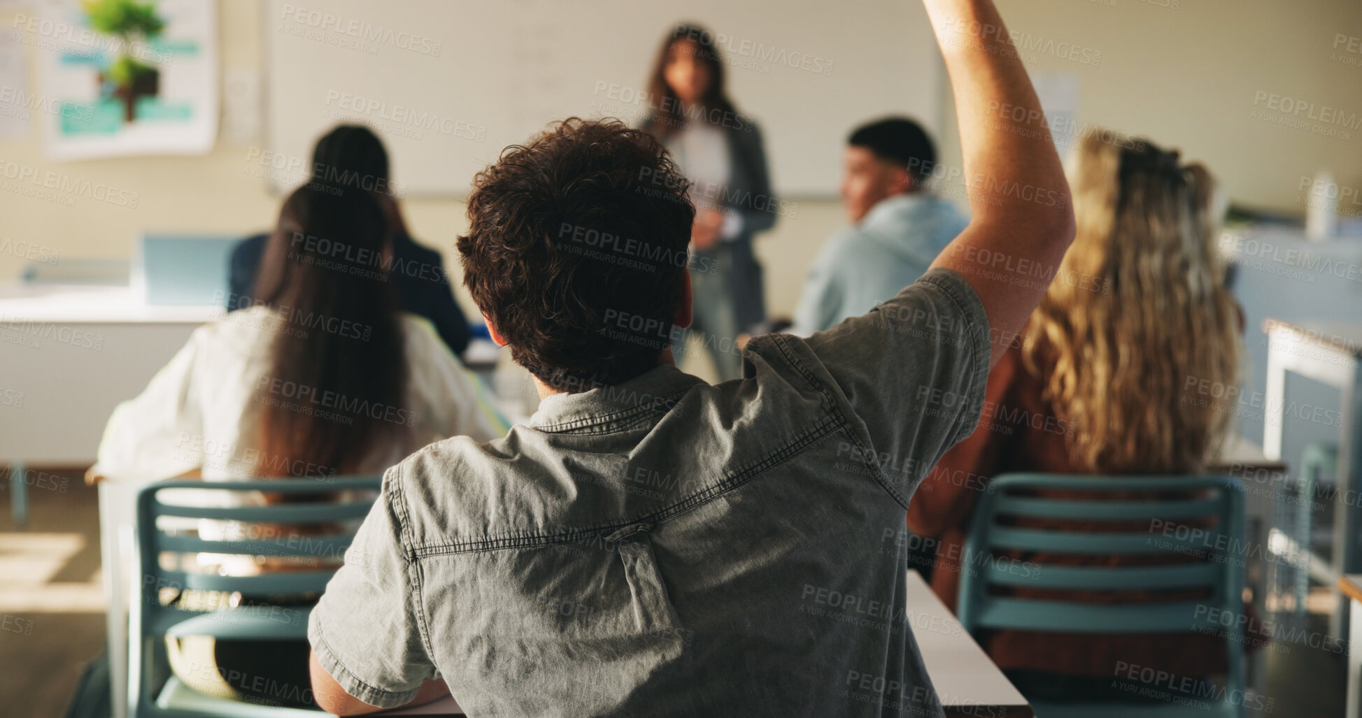 Buy stock photo Learning, man and raised hand for question in college, knowledge and development with teacher. Person, education or student ask in lesson, answer and participation from back at university classroom