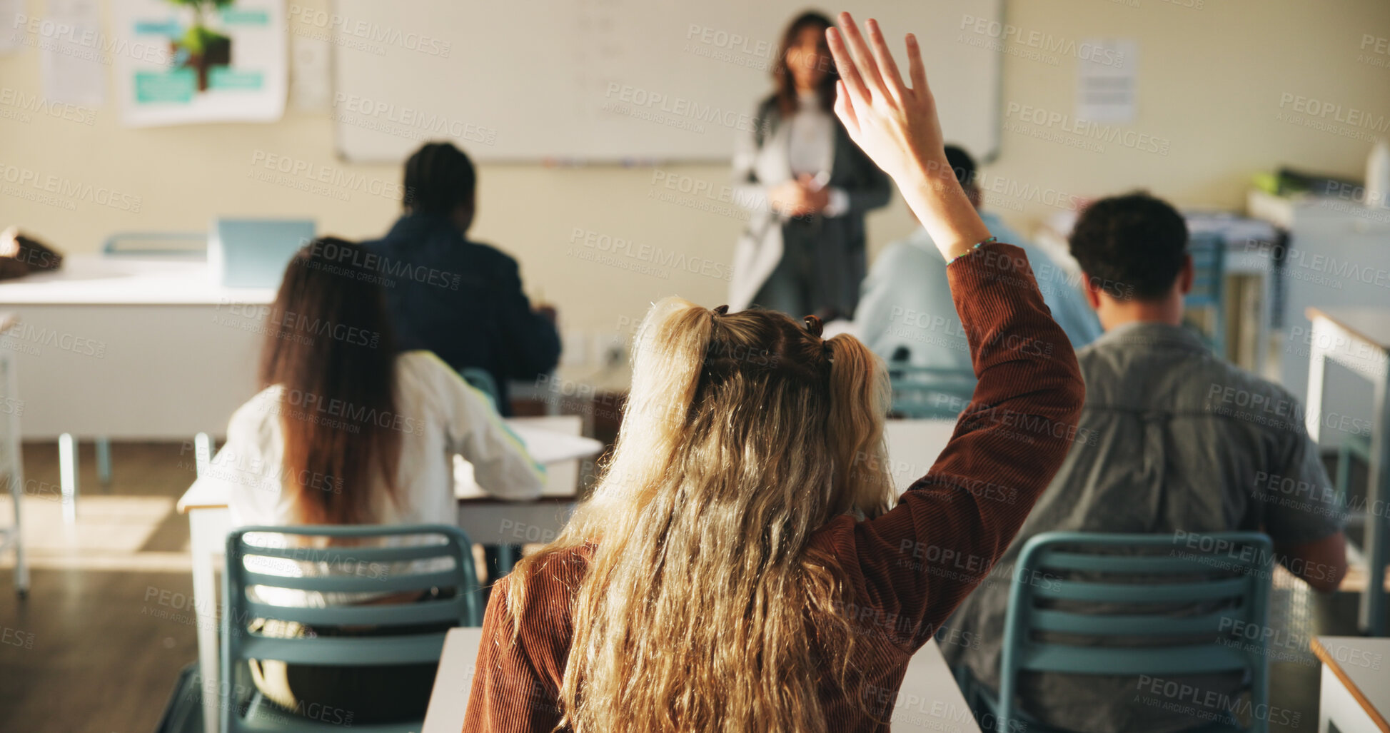 Buy stock photo Learning, woman and raised hand for question in college, knowledge and development with teacher. Person, education or student ask in lesson, answer and participation from back at university classroom