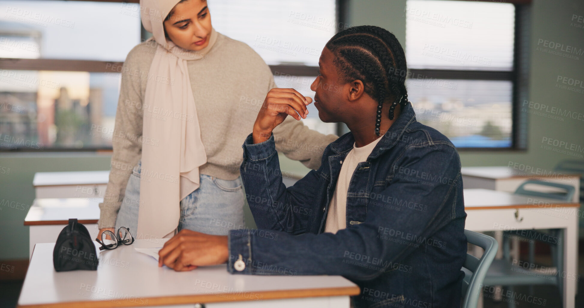 Buy stock photo Talking, teacher and student with guidance for education, development or study at university. Advice, conversation and woman speaking to man in classroom of college for feedback, help or support