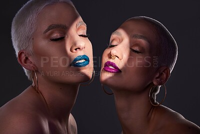Buy stock photo Makeup, glow and women or friends in studio for beauty or colorful cosmetics on dark background. Skincare, spotlight and people with eyes closed and bold aesthetic for edgy style or cool lipstick
