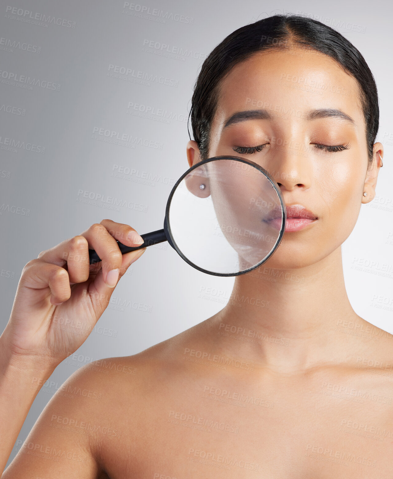 Buy stock photo Woman, magnifying glass or inspection for skincare in studio, zoom or acne search with cosmetic care. Female person, beauty investigation or face check for natural dermatology on white background