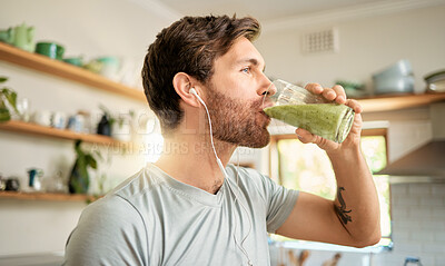 Buy stock photo Wellness, earphones and man in home with smoothie, organic juice and protein shake for gut health. Diet, person and audio tech in kitchen with green drink, supplement and nutritional tips in podcast