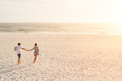 Buy stock photo Love, couple and holding hands at beach, sunset or travel on summer vacation for romance with partner. Man, woman and connection by ocean with happiness, back and walk with space on holiday together
