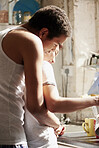 Romantic mixed race couple wearing pyjamas hugging making coffee in kitchen
