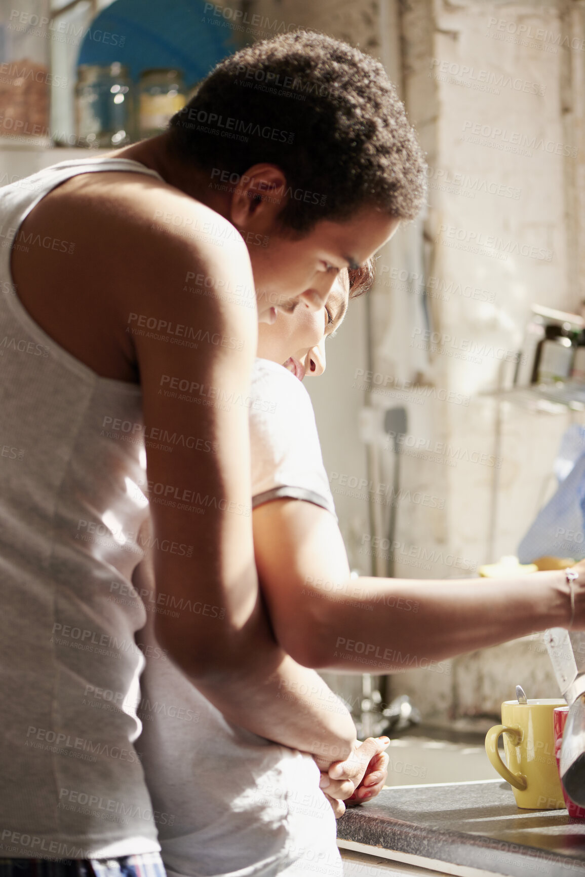 Buy stock photo Couple, hug and smile with tea in kitchen, together and morning routine with partner or relationship. Coffee, preparation and start day with spouse, embrace and happy people with connection in house