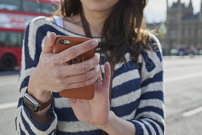 Buy stock photo Hands, woman and phone in city for travel with research, online location and bus schedule. Female person, mobile and reading for commute navigation, language translation and public transport for trip
