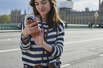 Beautiful woman using smart phone in the city internet connection communicating on social media