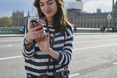 Buy stock photo Smile, woman and phone in city for travel with research, online location and bus schedule. Female person, mobile and reading for commute navigation, language translation and public transport for trip