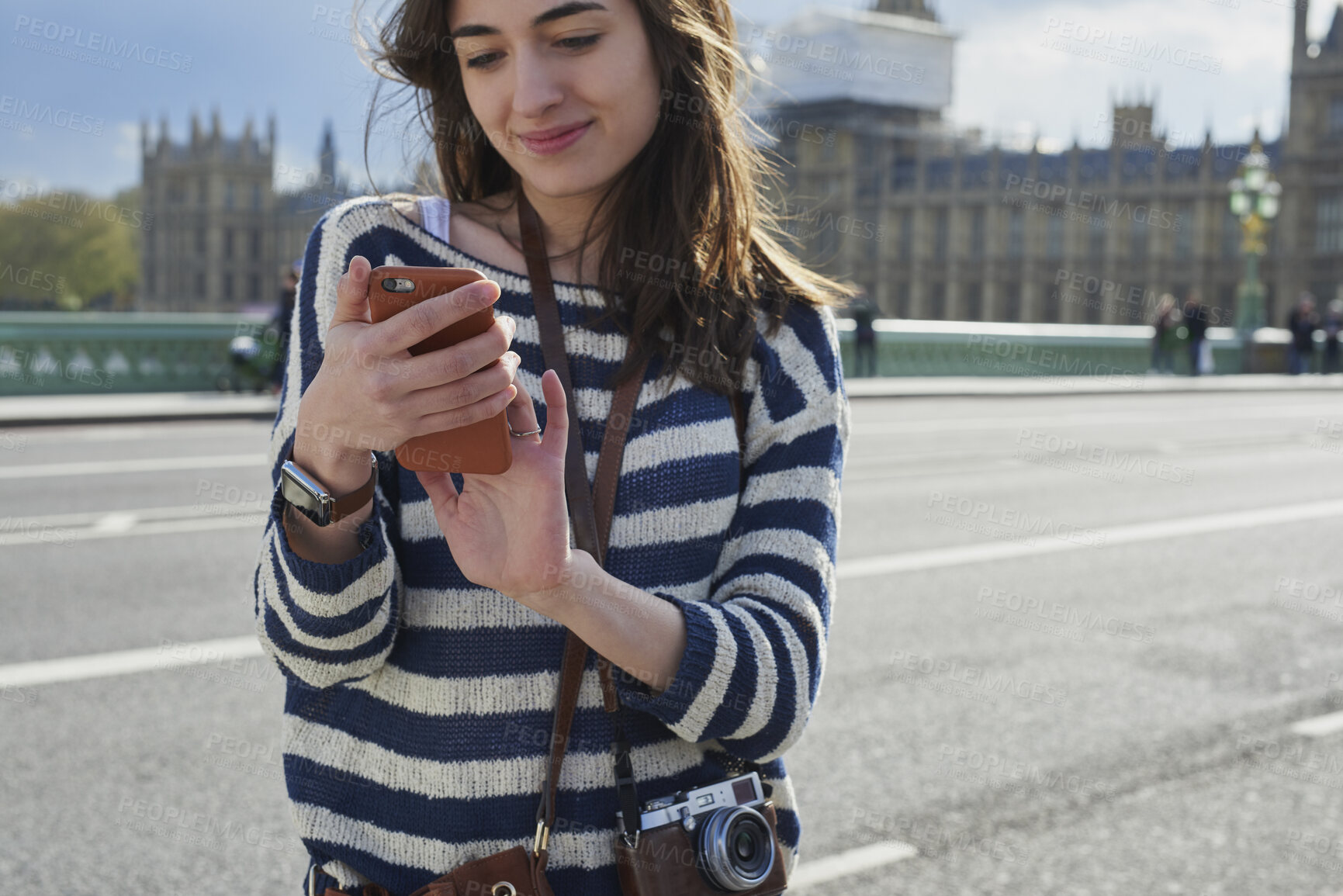 Buy stock photo Smile, woman and phone in city for travel with research, online location and bus schedule. Female person, mobile and reading for commute navigation, language translation and public transport for trip