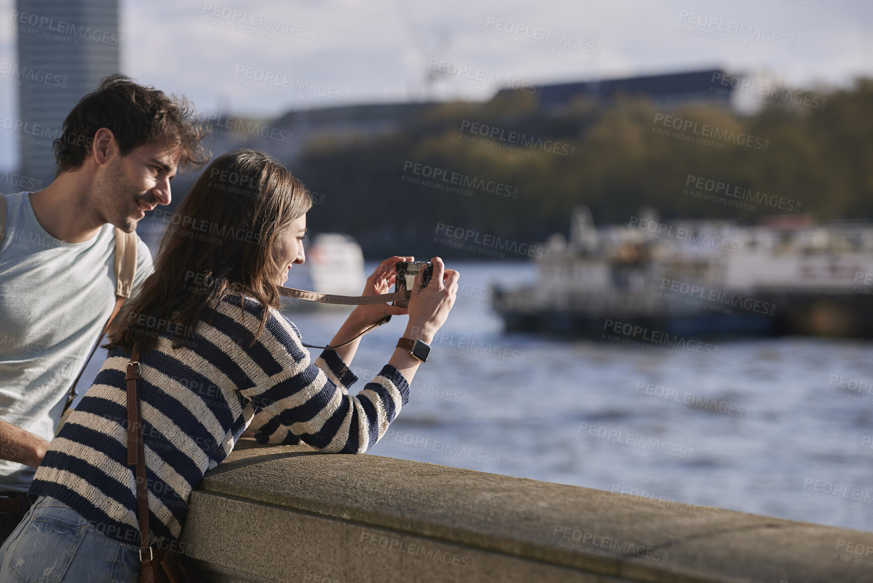 Buy stock photo City, travel and couple with camera by bridge, sightseeing holiday and abroad tourism for connection. Weekend trip, space or happy people with photography for vacation memory, bonding or capture town