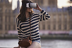 Beautiful travel woman wearing vr headset augmented virtual 3d reality environment experience concept in London at Westminster