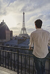 Travel man enjoying view Eiffel Tower Paris hotel terrace destination vacation