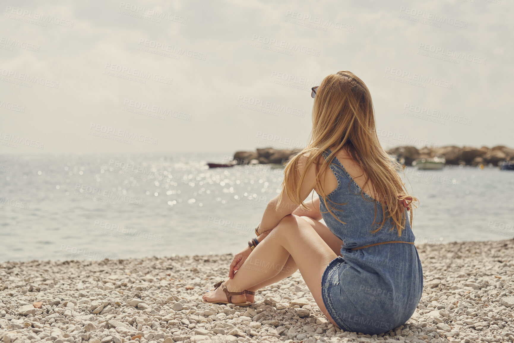 Buy stock photo Woman, travel and beach with back view by ocean, rest  or relax with coastal experience. Seaside, tourism and female person in nature, holiday or vacation with calm space, scenery or wellness outdoor