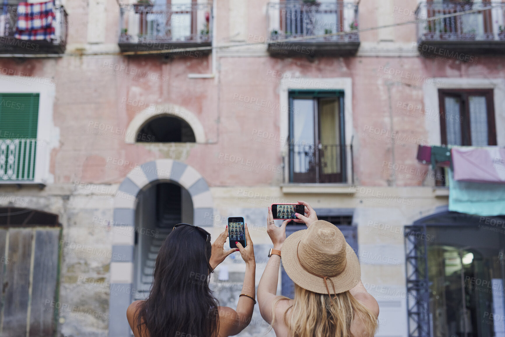 Buy stock photo Travel, picture or friends in town with phone, building photography or sightseeing post on summer trip. Tourism, back or women with tech, vacation connection or architecture capture in Italy.
