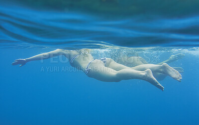 Buy stock photo Ocean, underwater and friends swimming for travel, wellness and floating in water for bonding. People, swimsuit and sea ripple space with stress relief, trip or break with support in summer activity