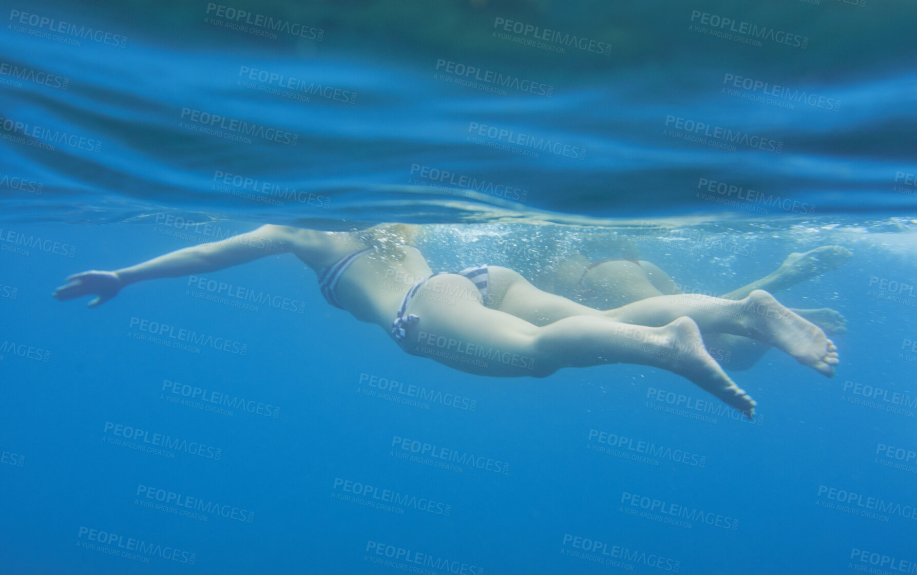 Buy stock photo Ocean, underwater and friends swimming for travel, wellness and floating in water for bonding. People, swimsuit and sea ripple space with stress relief, trip or break with support in summer activity
