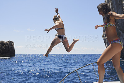 Buy stock photo Boat, jump and girl friends by ocean for adventure on summer holiday, getaway or weekend trip. Energy, blue sky and women with fun on yacht for freedom with swimming in sea on vacation together.