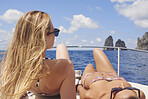 beautiful girl friends on speed boat having fun in bikini on travel adventure in Italy wanderlust