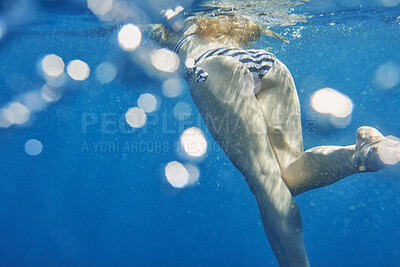 Buy stock photo Back, bikini and woman underwater in ocean for holiday, summer vacation or swimming. Behind, legs and tourist person in sea for break, getaway or trip as swimmer with bokeh for tourism and wellness
